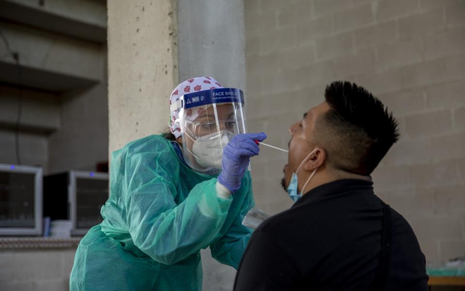 A health worker performs a coronavirus test to a local resident in Spain - Pablo Blazquez Dominguez/Getty