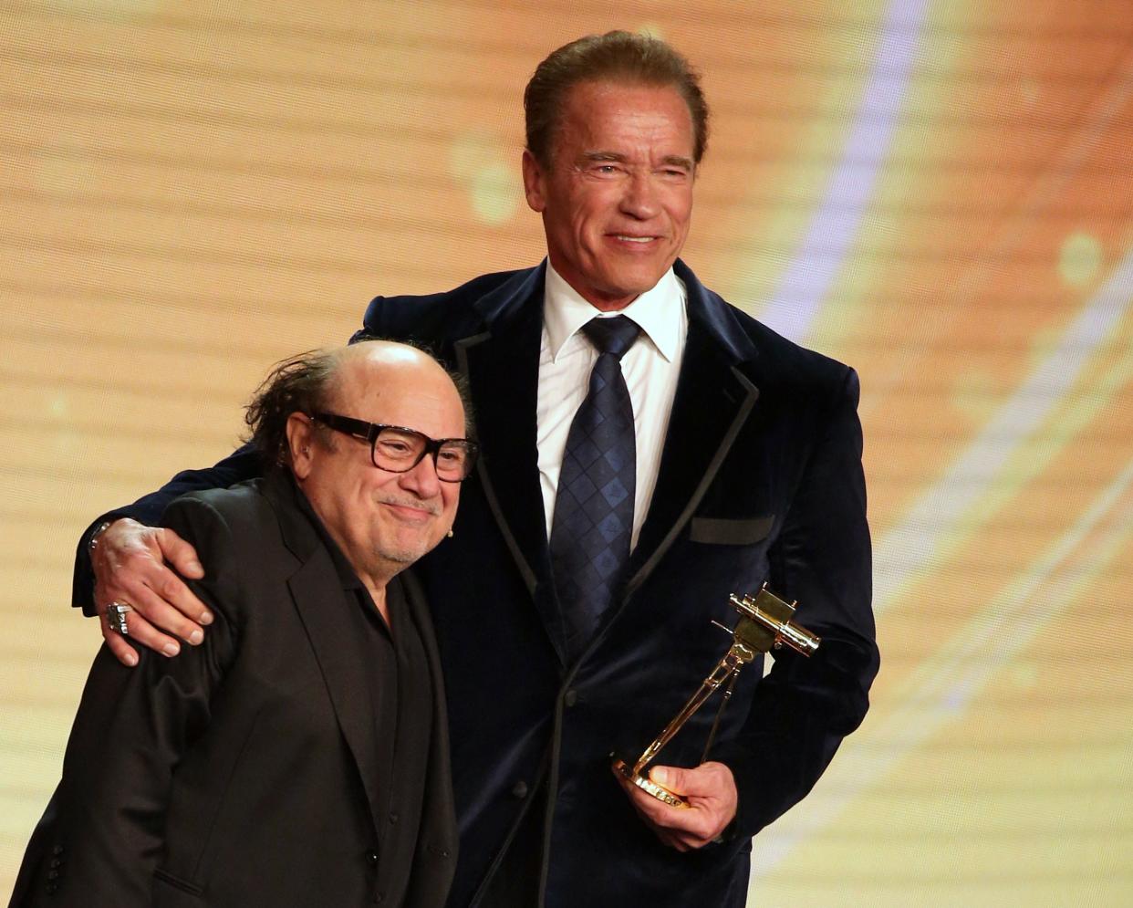 US actor and former governor of California Arnold Schwarzenegger (R) poses after receiving from US actor Danny DeVito his lifetime achievement award at the annual German film and television award ceremony Golden Camera ( Goldene Kamera ) in Hamburg, northern Germany, on February 27, 2015. AFP PHOTO / POOL / CHRISTIAN CHARISIUS        (Photo credit should read CHRISTIAN CHARISIUS/AFP via Getty Images)