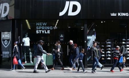 FILE PHOTO: People pass a JD Sports store in London, Britain, April 11, 2017. REUTERS/Neil Hall/File Photo