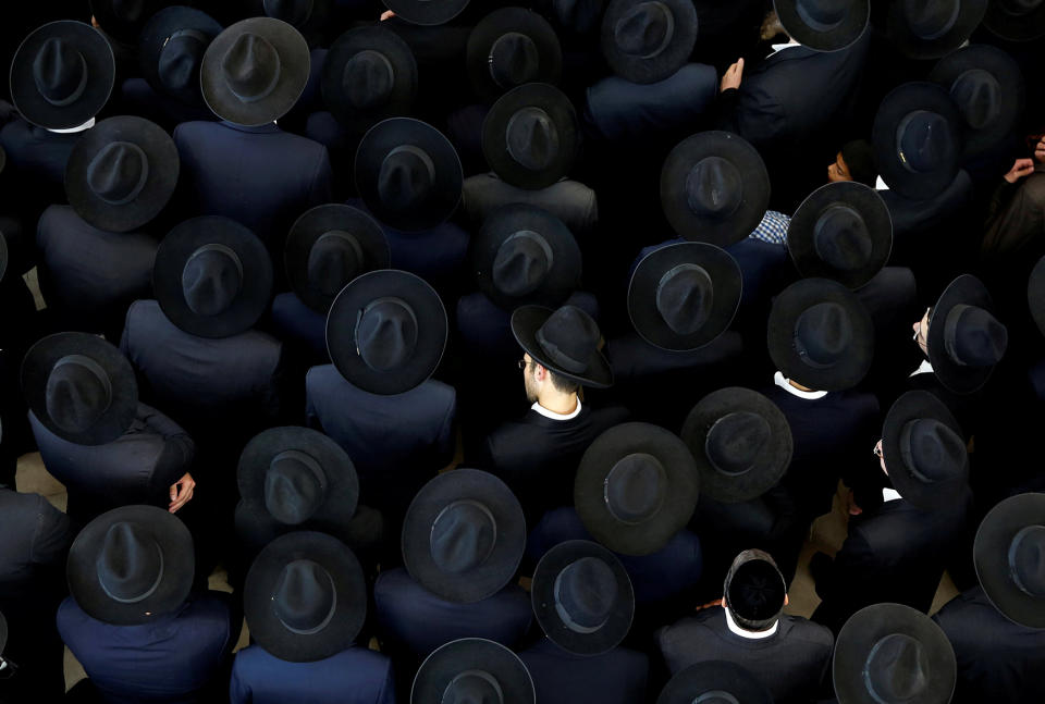 Ultra-Orthodox Jewish men take part in the funeral ceremony