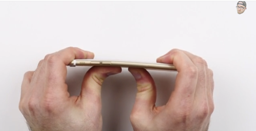Hands bending an iPhone 6