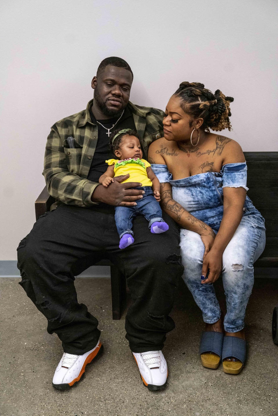 Kenyatta Jefferson, left, his daughter Shyne Powell, two months, and girlfriend Shermika Powell, at housing court in the 36th District Court in Detroit on June 5, 2023. (Sarah Rice for NBC News)