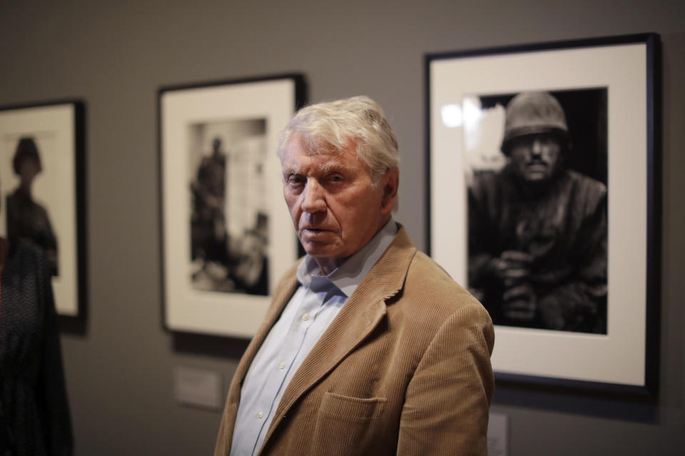 Veteran British conflict photographer Don McCullin poses for photographers at the launch of his retrospective exhibition at the Tate Britain gallery in London, Monday, Feb. 4, 2019. The exhibition includes over 250 of his black and white photographs, including conflict images from the Vietnam war, Northern Ireland, Cyprus, Lebanon and Biafra, alongside landscape and still life images. (AP Photo/Matt Dunham)