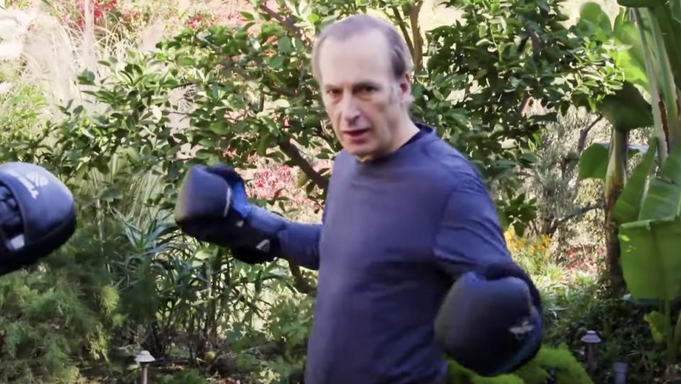 Bob Odenkirk wearing boxing gloves standing outside