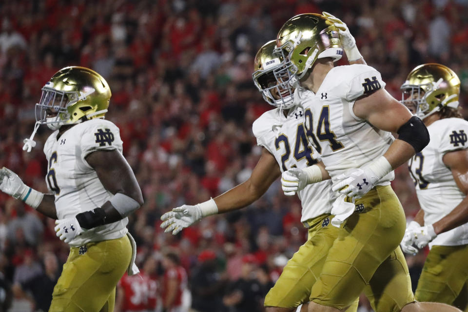 Notre Dame tight end Tommy Tremble (24) celebrates the touchdown of Notre Dame tight end Cole Kmet (84) during the first half of an NCAA college football game against Georgia, Saturday, Sept. 21, 2019, in Athens, Ga. (AP Photo/John Bazemore)