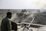 This photo released Tuesday, Jan. 19, 2021, by the Iranian Army, shows armored vehicles during a military drill. Iran's military kicked off a ground forces drill on Tuesday along the coast of the Gulf of Oman, state TV reported, the latest in a series of snap exercises that the country is holding amid escalating tensions over its nuclear program and Washington's pressure campaign against Tehran. (Iranian Army via AP)