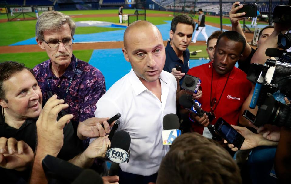 FILE - Miami Marlins CEO Derek Jeter, center, talks with members of the media before the start of a baseball game between the Marlins and the St. Louis Cardinals, in Miami, June 10, 2019. Jeter announced a surprise departure from the Miami Marlins Monday, Feb. 28, 2022. (AP Photo/Wilfredo Lee, File)