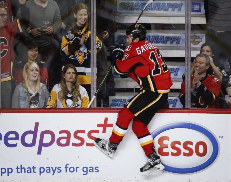 Pittsburgh Penguins fans look on as Calgary Flames left wing Johnny Gaudreau (13) celebrates his goal during third period NHL hockey action in Calgary, Monday, March 13, 2017. (Jeff McIntosh/The Canadian Press via AP)