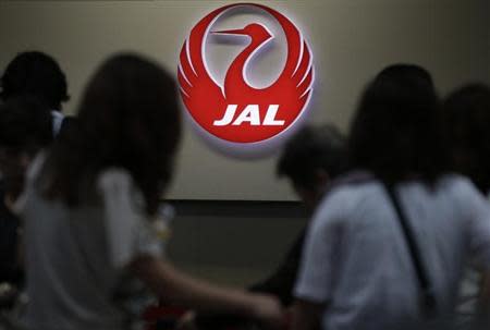 A logo of Japan Airlines is seen at the passengers' check-in counter at Haneda airport in Tokyo September 10, 2012. REUTERS/Toru Hanai