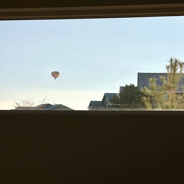 a hot air balloon through the window
