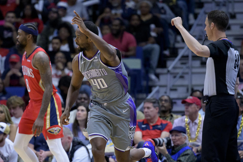 Sacramento Kings forward Harrison Barnes (40) celebrates a 3-point basket next to New Orleans Pelicans forward Naji Marshall, left, during the first half of an NBA basketball game in New Orleans, Tuesday, April 4, 2023. (AP Photo/Matthew Hinton)