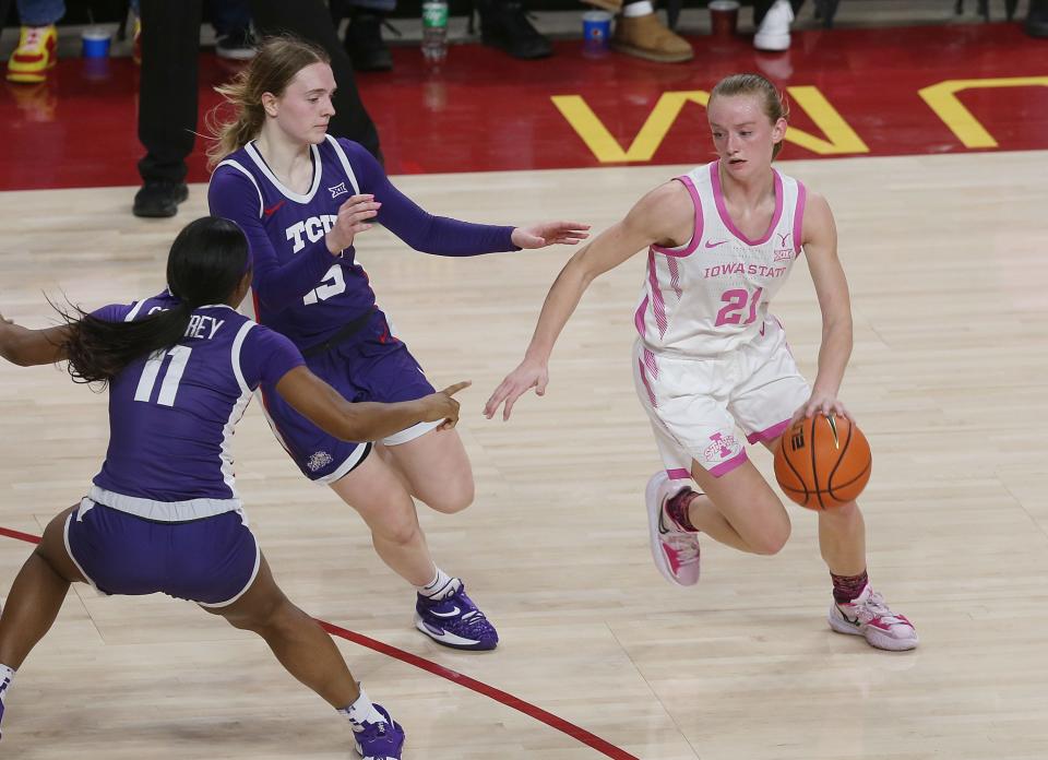 Iowa State’s Lexi Donarski drives around TCU defenders during the third quarter at Hilton Coliseum on Feb. 25.