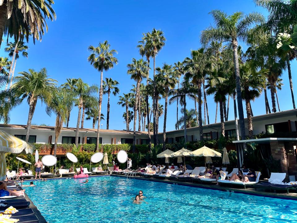 The Hollywood Roosevelt’s Tropicana Pool, which is lined with David Hockney’s million-dollar swirls of paint and surrounded by 230 towering palm trees.