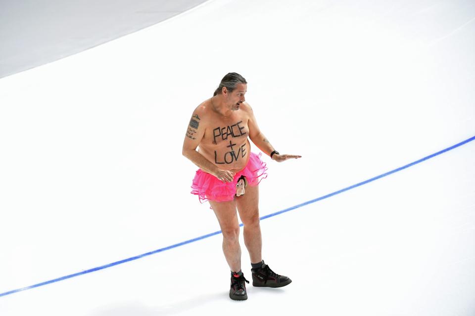 <p>A shirtless man clad in a tutu dances on the rink following the men’s 1,000m speed skating event medal ceremony during the Pyeongchang 2018 Winter Olympic Games at the Gangneung Oval in Gangneung on February 23, 2018. / AFP PHOTO / Roberto SCHMIDT </p>