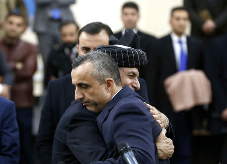 Afghanistan's President Ashraf Ghani hugs his first vice president candidate Amrullah Saleh, after arriving to register as a candidate for the upcoming presidential election at the Afghanistan's Independent Election Commission (IEC) in Kabul, Afghanistan January 20, 2019. REUTERS/Omar Sobhani