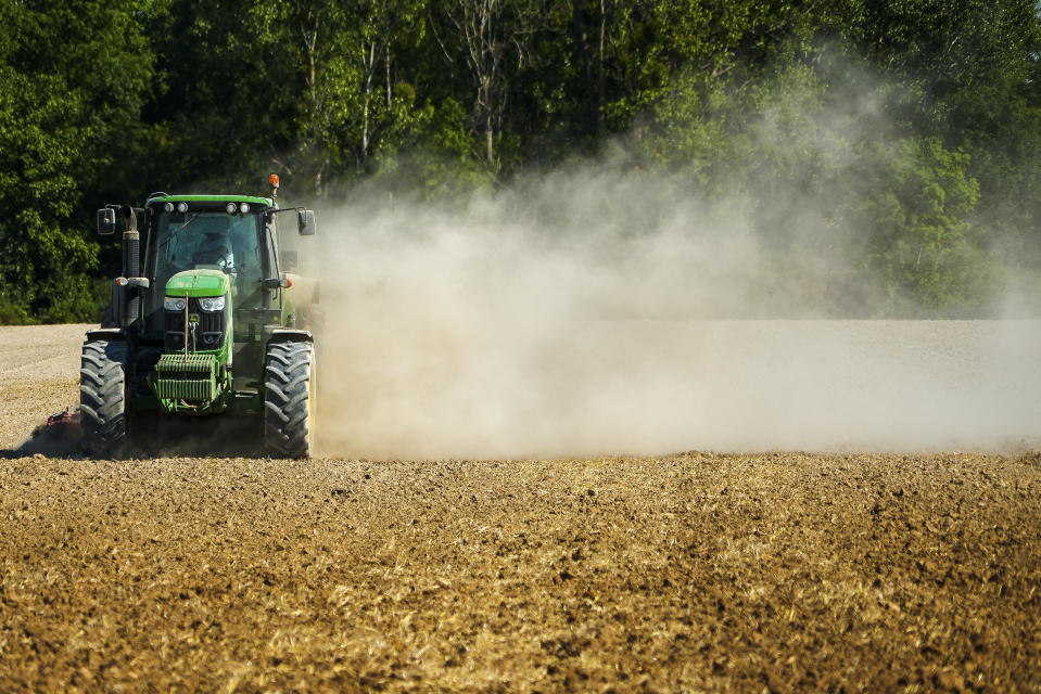 A tractor throws up a cloud of dust as it works in a sun-dried field in Til-Chatel, France, Tuesday Aug. 9, 2022. Burgundy, home to the source of the Seine River which runs through Paris, normally is a very green region. This year, grass turned yellow, depriving livestock from fresh food, and tractors send giant clouds of dust in the air as farmers work in their dry fields. (AP Photo/Nicholas Garriga)