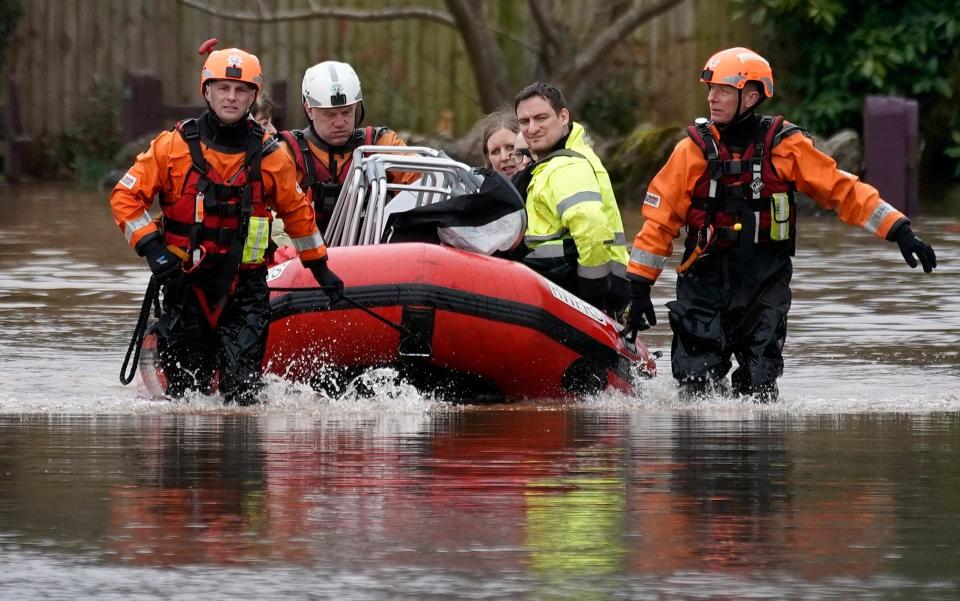 irefighters rescue staff and residents from a care home in the village of Whitchurch on the banks of the River Wye - getty