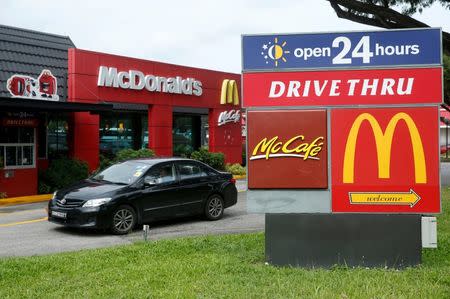 A car passes a McDonald's drive through restaurant in Singapore July 25, 2016. Picture taken July 25, 2016. REUTERS/Edgar Su