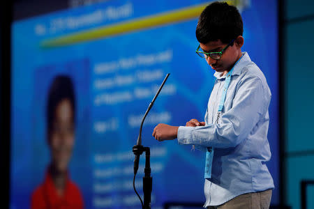 Naveenth Murali spells a word on his forearm during the Scripps National Spelling Bee at National Harbor in Oxon Hill, Maryland, U.S., May 31, 2018. REUTERS/Aaron P. Bernstein