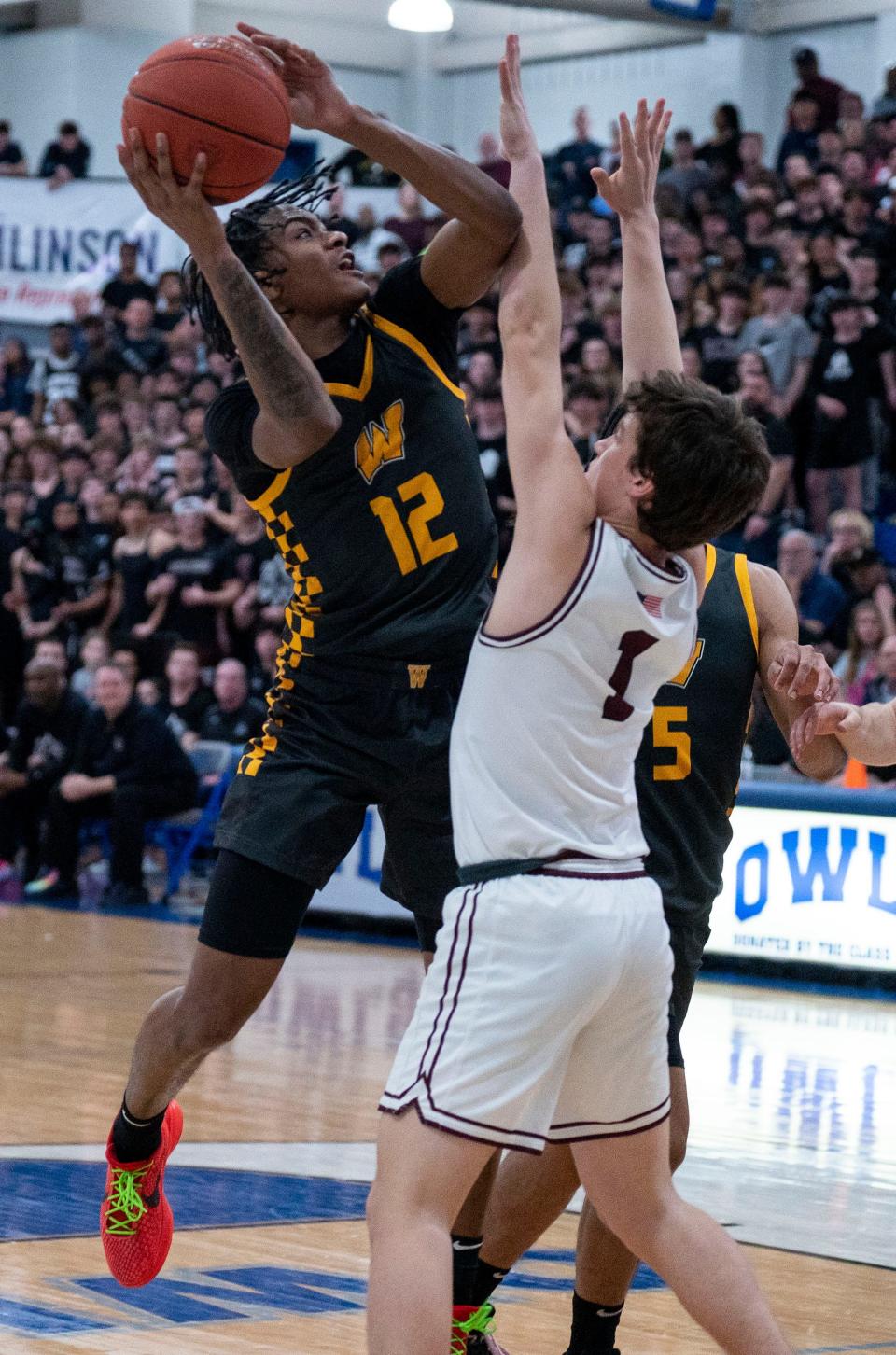 Archbishop Wood's Tahir Howell (12) shoots inside against Lower Merion's Gus Wright on Wednesday.