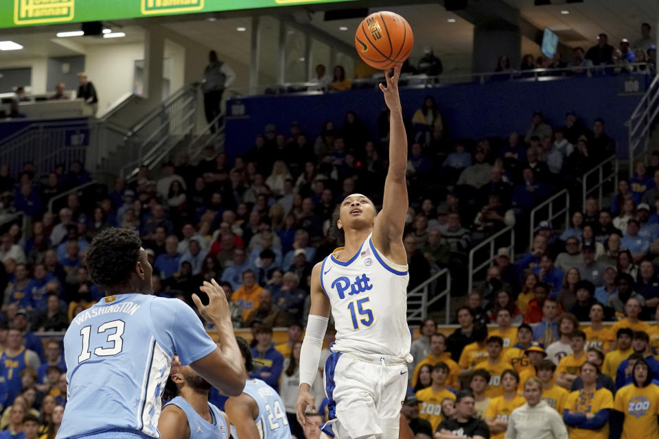 Pittsburgh guard Jaland Lowe (15) puts a shot up in front of North Carolina forward Jalen Washington (13) during the first half of an NCAA college basketball game Tuesday, Jan. 2, 2024, in Pittsburgh. (AP Photo/Matt Freed)