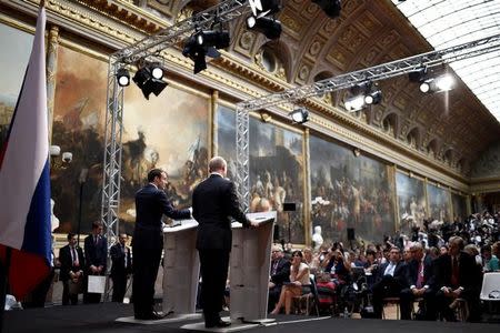 French President Emmanuel Macron (L) and Russian President Vladimir Putin give a joint press conference at the Chateau de Versailles before the opening of an exhibition marking 300 years of diplomatic ties between the two countries in Versailles, France, May 29, 2017. REUTERS/Stephane De Sakutin/Pool