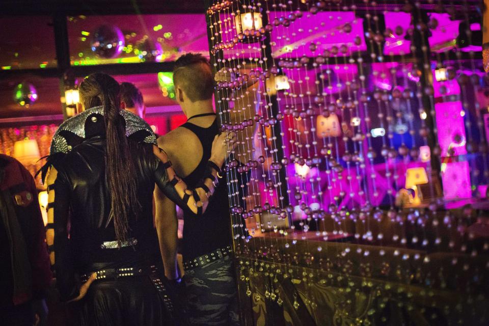 In this photo taken Saturday, Feb. 8, 2014, workers wait for customers to arrive before a performance at the Mayak cabaret, the most reputable gay club in Sochi, Russia, host to 2014 Winter Olympics. Russia adopted a law last year, prohibiting vaguely defined propaganda of non-traditional sexual relations and pedophilia. The legislation makes it illegal to disseminate information to children even if it merely shows that gay people are just like everybody else. At Mayak, packed on Saturday night, gay men and women steered away from discussing the law, preferring to enjoy life, closeted as it is. About a hundred people were chatting at the bar, sitting in armchairs or dancing. Couples were sharing kisses. Everyone was waiting for the club's specialty: a drag show. At 1.30 a.m. on Sunday, the music stopped and the show began. (AP Photo/David Goldman)