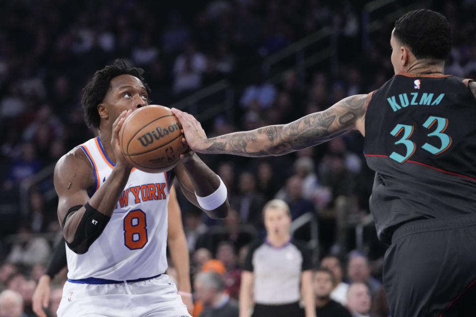 /Washington Wizards forward Kyle Kuzma (33) guards against New York Knicks forward OG Anunoby (8) in the first half of an NBA basketball game, Thursday, Jan. 18, 2024, at Madison Square Garden in New York. (AP Photo/Mary Altaffer)