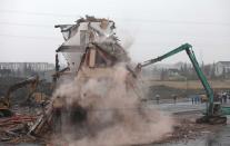 Bulldozers destroyed the home of Luo Baogen and his family, after his "nail house" in Wenling city, China, circulated became a worldwide sensation on the Web. (Rex)