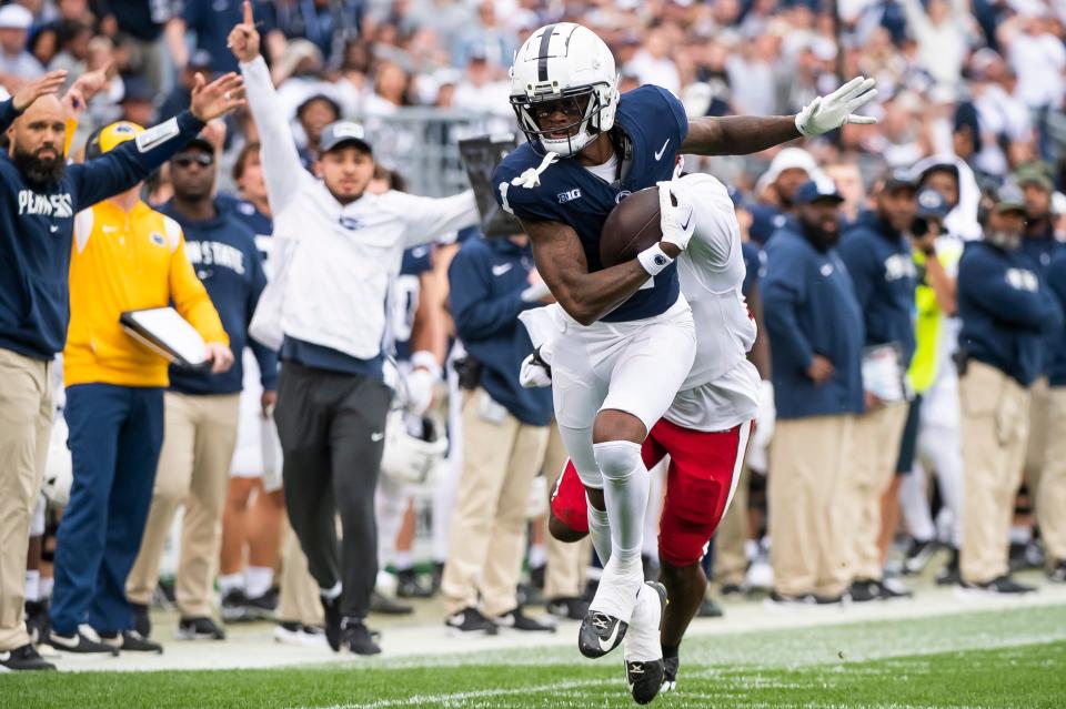 Penn State wide receiver KeAndre Lambert-Smith walks a tightrope along the sideline as he goes the distance on a 57-yard touchdown reception late in the fourth quarter of an NCAA football game against Indiana at Beaver Stadium Saturday, Oct. 28, 2023, in State College, Pa. Lambert-Smith's touchdown broke a 24-24 tie and helped seal a 33-24 win for the Nittany Lions.