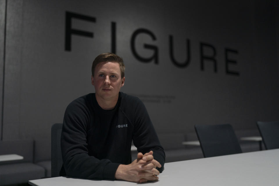 FILE - Figure AI CEO Brett Adcock sits for a photo at the company's test facility in Sunnyvale, Calif., Oct. 3, 2023. ChatGPT-maker OpenAI is looking to fuse its artificial intelligence systems into the bodies of humanoid robots as part of a new deal with robotics startup Figure. Sunnyvale, California-based Figure announced the partnership Thursday, Feb. 29, 2024, along with $675 million in venture capital funding from a group that includes Amazon founder Jeff Bezos as well as Microsoft, chipmaker Nvidia and the startup-funding divisions of Amazon, Intel and OpenAI. (AP Photo/Jae C. Hong, File)