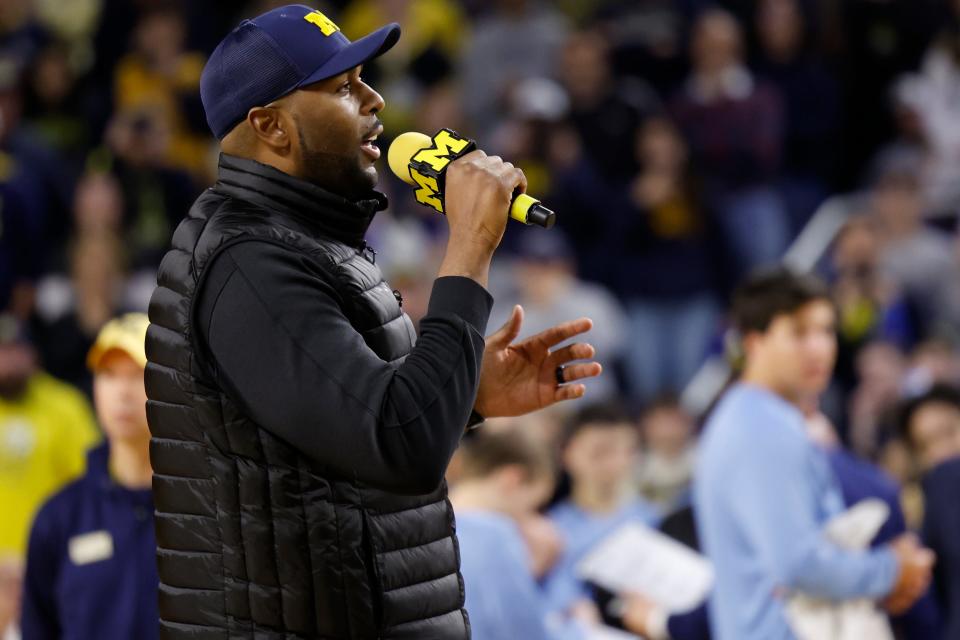 Michigan Wolverines head football coach Sherrone Moore addresses the basketball crowd during a timeout against the Iowa Hawkeyes at Crisler Center in Ann Arbor on Saturday, Jan. 27, 2024.