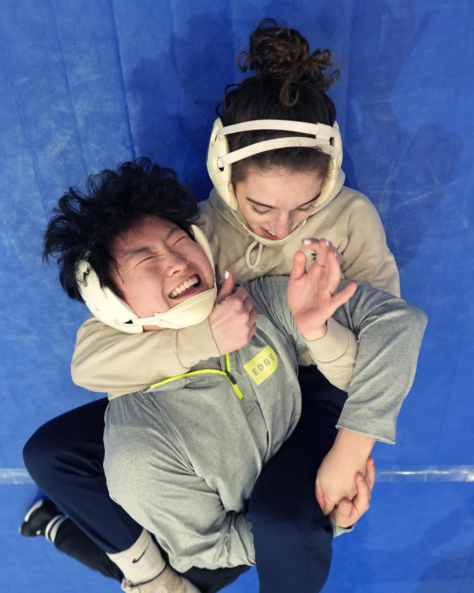 North Central women's wrestling team's Amani Jones, right, works with Yele Aycock during a practice at the Alliant Energy Powerhouse arena in Cedar Rapids, Iowa, Wednesday, March 6, 2024. The team is a national powerhouse even though the program is only a few years old and the school is D-III. (AP Photo/Nam Y. Huh)