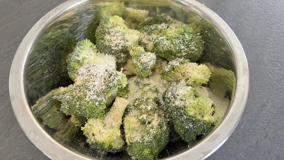 Broccoli in bowl with seasoning