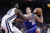 Sacramento Kings forward Nemanja Bjelica, right, goes to the basket against Memphis Grizzlies forward Jaren Jackson Jr. during the first quarter of an NBA basketball game in Sacramento, Calif., Thursday, Feb. 20, 2020. (AP Photo/Rich Pedroncelli)