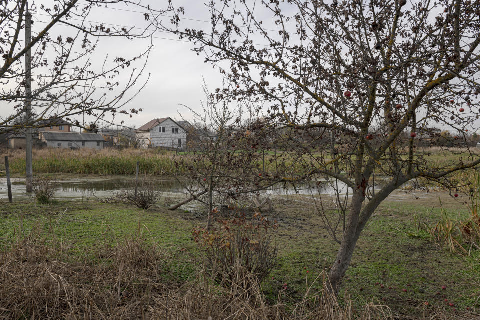 A view of a flooded area in the village of Demydiv, about 40 kilometers (24 miles) north of Kyiv, Ukraine, Tuesday, Nov. 2, 2022. Because of the war, more than 6 million Ukrainians have limited or no access to clean water, and more than 280,000 hectares (nearly 692,000 acres) of forests have been destroyed or felled, according to the World Wildlife Fund. (AP Photo/Andrew Kravchenko)