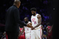 Philadelphia 76ers' Joel Embiid (21) and James Harden (1) walk off the court during a timeout in the second half of an NBA basketball game against the Chicago Bulls, Monday, March 20, 2023, in Philadelphia. (AP Photo/Matt Slocum)