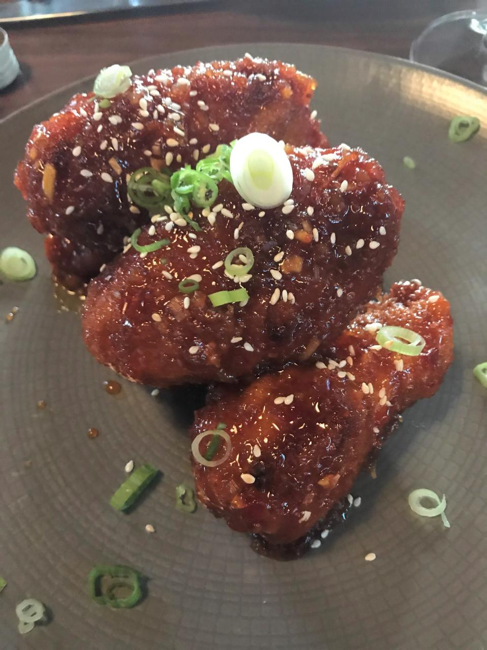REDD wings with Thai chili glaze and sesame seeds are among the dishes in the restaurant's takeout menu.