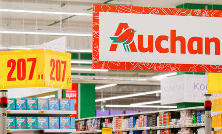 FILE PHOTO: The logo of French retailer Auchan is pictured at company's hypermarket in Moscow, Russia, May 19, 2017. REUTERS/Maxim Shemetov/File Photo