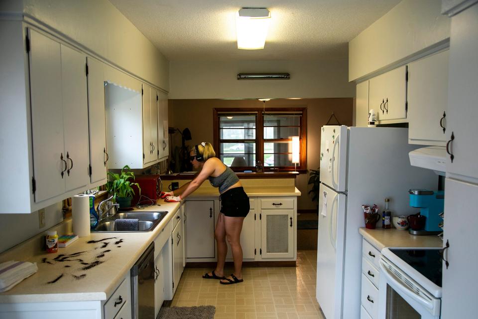 Hannah Kelley attempts a task in the kitchen at the University of Northern Iowa Dementia Simulation House, Tuesday, May 10, 2022, in Cedar Falls, Iowa.