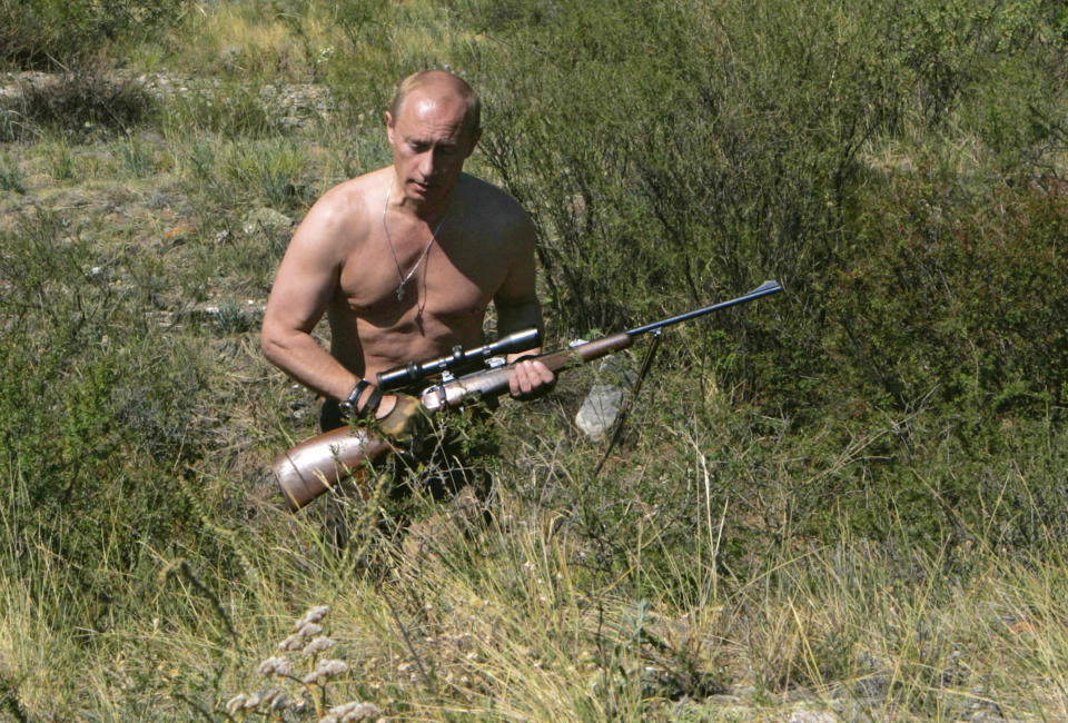 Then President Vladimir Putin, wearing a blue helmet and an oxygen mask, sits in Su-27 fighter jet after his flight into the war zone in Chechnya, in Grozny, Russia. Putin has become alternately notorious and beloved for an array of adventurous stunts, including posing with a tiger cub and riding a horse bare-chested. (AP Photo/ITAR-TASS, Presidential Press Service, file)