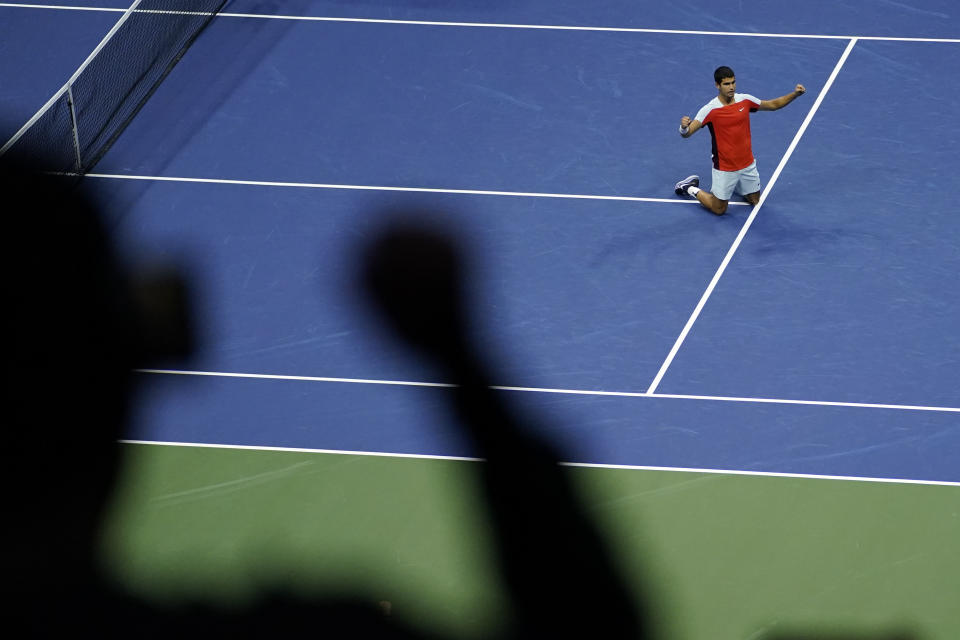 Carlos Alcaraz, of Spain, kneels on the court after beating Jannik Sinner, of Italy, during the quarterfinals of the U.S. Open tennis championships, early Thursday, Sept. 8, 2022, in New York. (AP Photo/Julia Nikhinson)