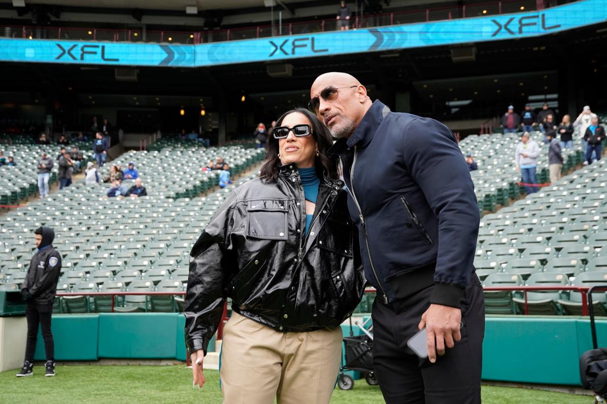 XFL owners Dany Garcia and Dwayne Johnson stand on the field prior to a game between the Vegas Vipers and the Arlington Renegades at Choctaw Stadium.