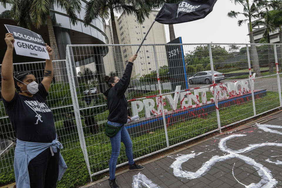 Demonstrators protest against the Prevent Senior health care company outside its headquarters in Sao Paulo, Brazil, Sept. 30, 2021. Whistleblowing doctors, through their lawyer, testified at the Senate last week that Prevent Senior enlisted participants to test unproven drugs without proper consent and forced doctors to toe the line on prescribing unproven drugs touted by President Jair Bolsonaro as part of a “COVID kit,” in the treatment of the new coronavirus. (AP Photo/Marcelo Chello)