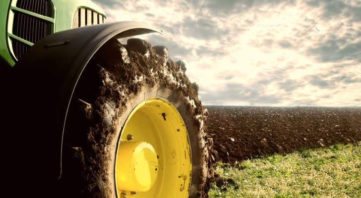 a tractor tire pictured in a field on the tractor