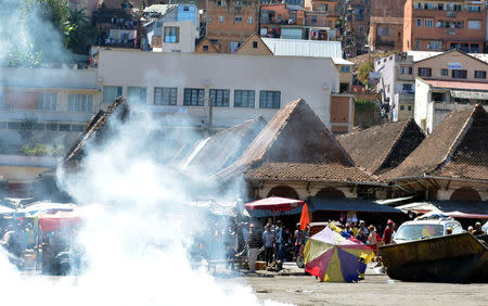 Riot police fire tear gas canisters at a market to disperse opposition demonstrators protesting against new electoral laws in Antananarivo, Madagascar April 21, 2018. REUTERS/Clarel Faniry Rasoanaivo