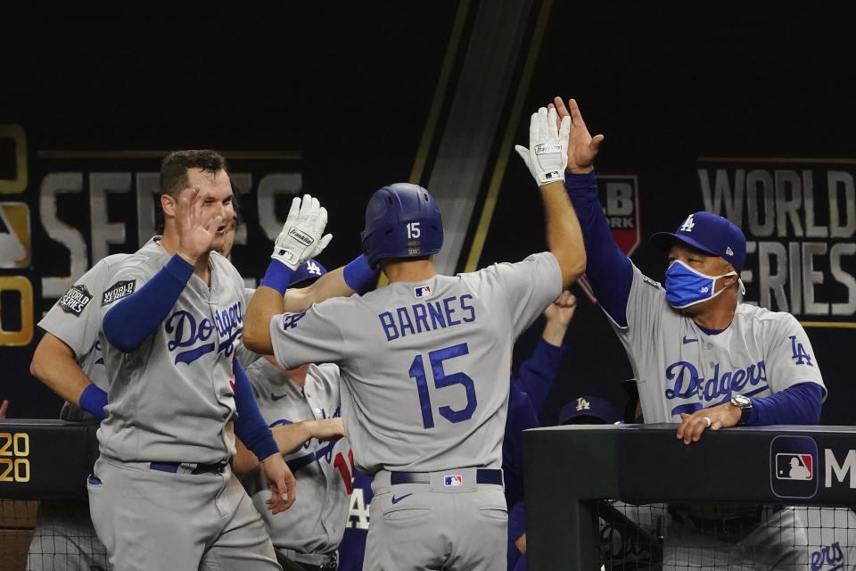 Los Angeles Dodgers' Austin Barnes celebrates a home run during the sixth inning in Game 3 of the baseball World Series against the Tampa Bay Rays Friday, Oct. 23, 2020, in Arlington, Texas. (AP Photo/Tony Gutierrez)