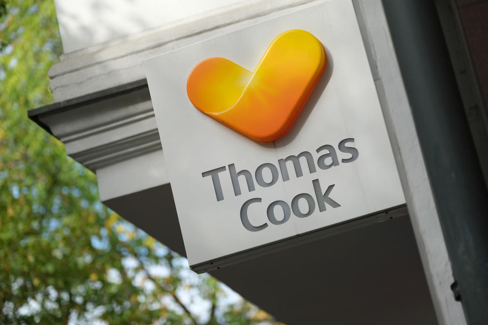 BERLIN, GERMANY - SEPTEMBER 26: The logo of the Thomas Cook travel group hangs above a travel agency on September 26, 2019 in Berlin, Germany. Thomas Cook Germany, which includes Thomas Cook GmbH, Bucher Reisen and Öger Tours, announced today that it is cancelling all travels booked through October 13 as part of its recent announcement to file for bankruptcy following the bankruptcy of Thomas Cook Group in the United Kingdom. (Photo by Sean Gallup/Getty Images)