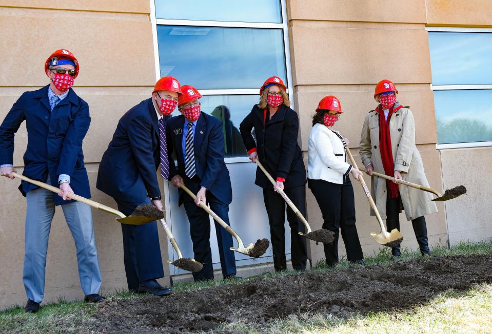 University and community leadership, including University of South Dakota President Sheila Gestring, Dean of the School of Health Sciences Haifa Abou Samra, Senator Arthur Rusch and Delta Dental President and CEO Scott Jones, break ground on the new School of Health Sciences building on Thursday, April 1, 2021, in Vermillion.