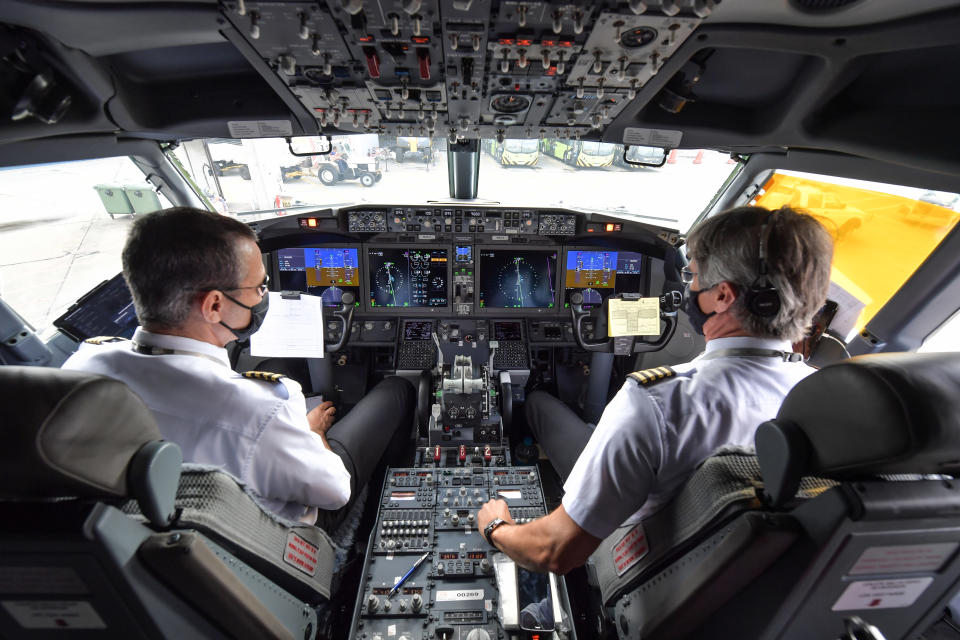 Pilots are pictured in the cockpit of a Boeing 737 MAX aircraft operated by low-cost airline Gol as it sits on the tarmac before take off at Guarulhos International Airport, near Sao Paulo on December 9, 2020, as the 737 MAX returns into use more than 20 months after it was grounded following two deadly crashes. (Photo by NELSON ALMEIDA / AFP) (Photo by NELSON ALMEIDA/AFP via Getty Images)